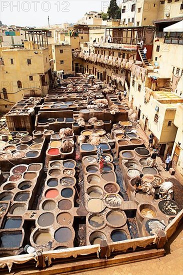 Workers dyeing leather