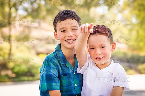 Outdoor portrait of biracial chinese and caucasian brothers