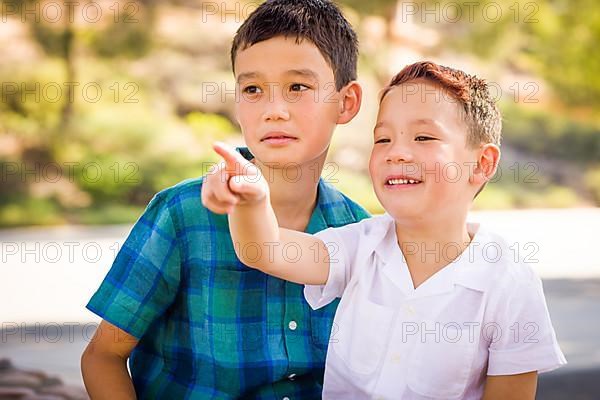 Outdoor portrait of biracial chinese and caucasian brothers