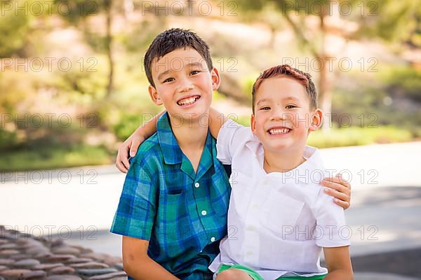 Outdoor portrait of biracial chinese and caucasian brothers