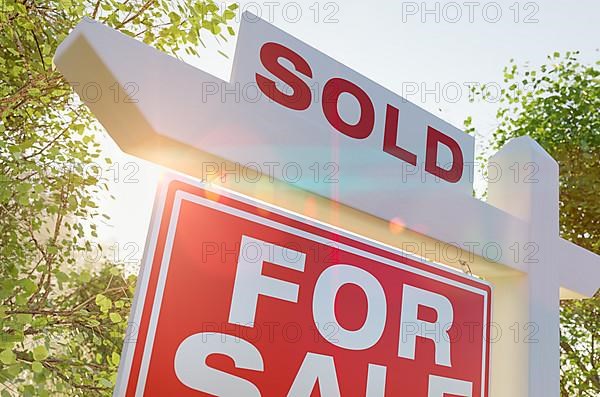 Sold for sale real estate sign in front of property