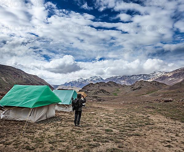 Photographer taking photos in Himalayas mountains with mobile phone. Spiti valley