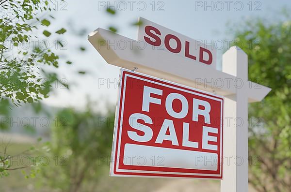 Sold for sale real estate sign in front of property