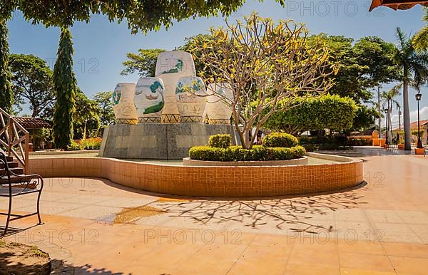 Image of a nice and relaxed park with a water fountain surrounded by trees