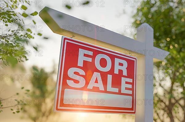 For sale real estate sign in front of property