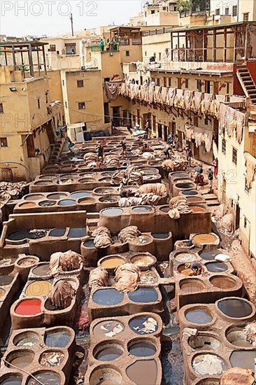 Workers dyeing leather