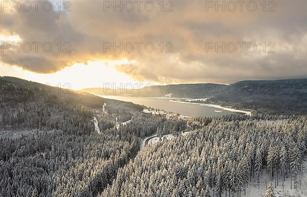 Aerial view of a winter landscape with lake at sunrise