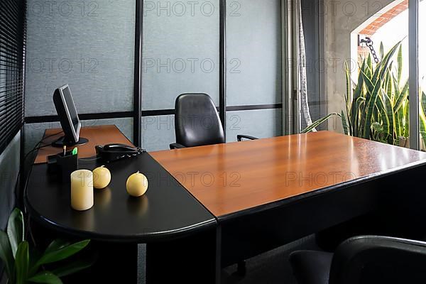 Empty office in a classic style with a large desk and a large window