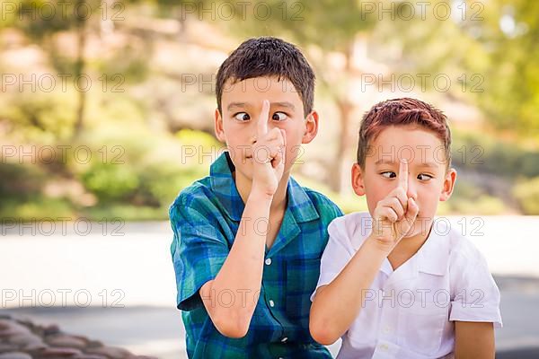 Outdoor portrait of biracial chinese and caucasian brothers having fun