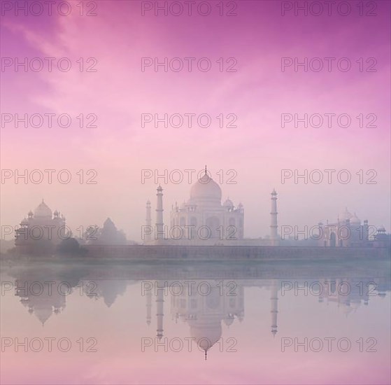 Taj Mahal on sunrise sunset reflection in Yamuna river panorama in fog