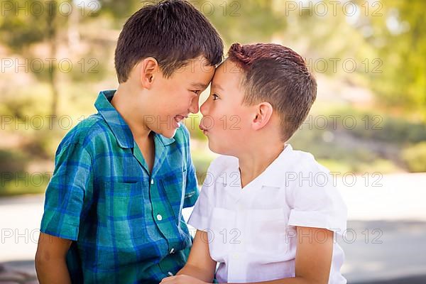 Outdoor portrait of biracial chinese and caucasian brothers having fun