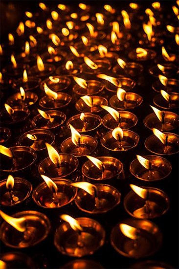 Burning candles in Tibetan Buddhist temple. Himachal Pradesh