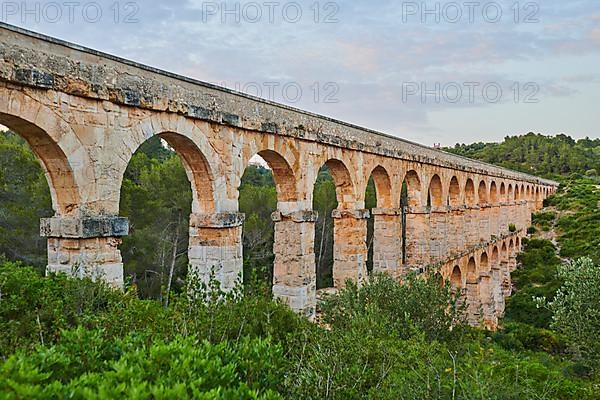 Old roman aqueduct at sunrise