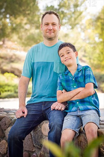 Outdoor portrait of biracial chinese and caucasian father and son