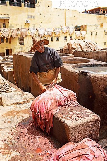 Workers scraping the flesh from the skin