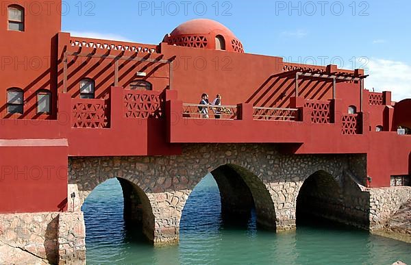 Bridge with buildings over lagoon