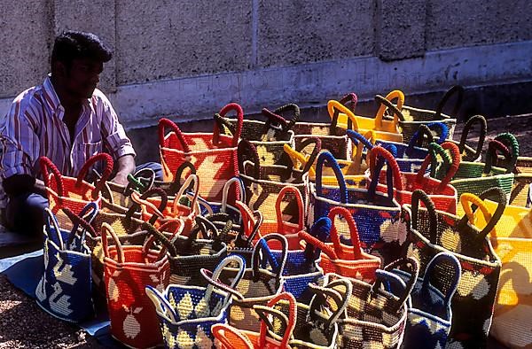 A vendor with plastic crochet wire bags for sale at Coimbatore