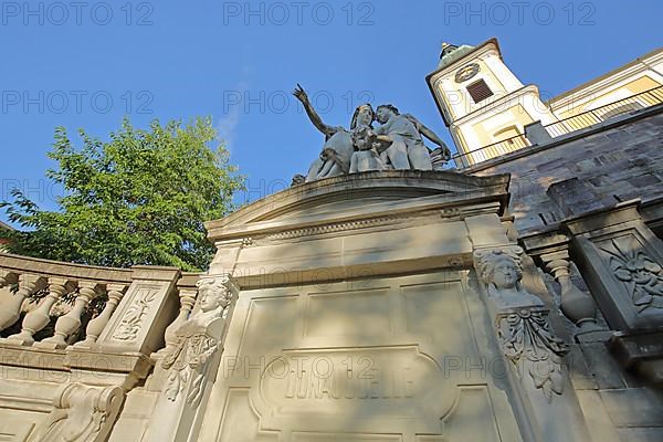 Donauquelle with figures of Mother Baar and the tower of St. John's Church in Donaueschingen