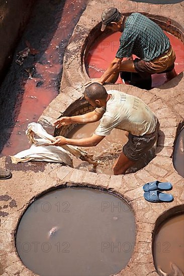 Workers dyeing leather