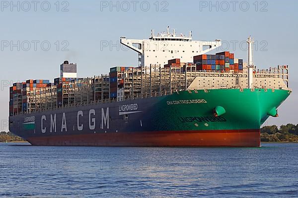Container ship CMA CGM TROCADERO powered by liquefied natural gas LNG leaves the port of Hamburg on the river Elbe