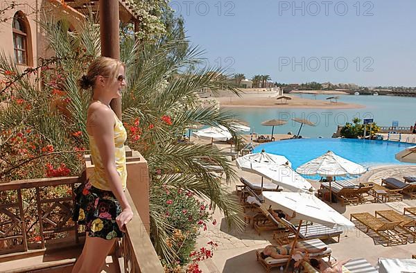 Young woman looking from balcony