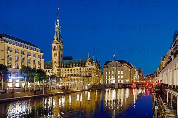 Illuminated City Hall with Little Alster and Alsterarkarden in the evening