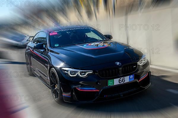 Dynamic photo with zoom effect of sports car race car BMW M4 leaving pit lane