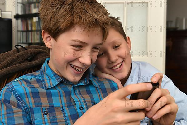 Boys play mobile phone games