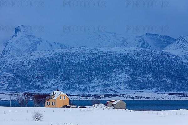 Wooden huts at Limstranden in the snow in winter