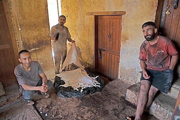 Workers sorting leather