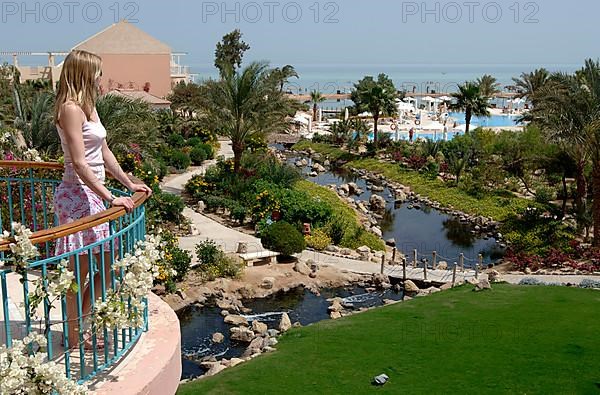 Young woman looking from balcony