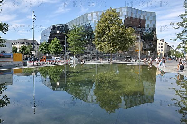 Reflection of the university library in the water surface at the square of the old synagogue in Freiburg