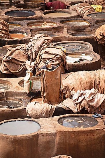 Workers dyeing leather