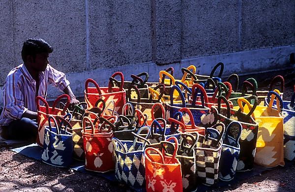 A vendor with plastic crochet wire bags for sale at Coimbatore