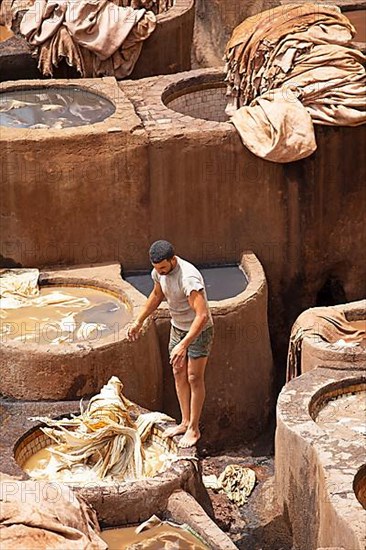 Workers dyeing leather