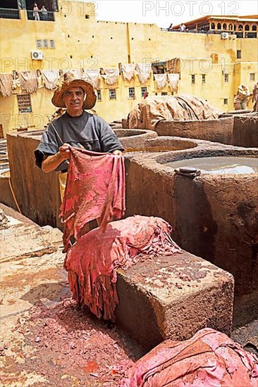 Workers scraping the flesh from the skin