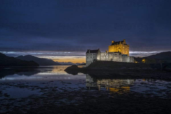 Illuminated Eilean Donan Castle at night in Loch Duich