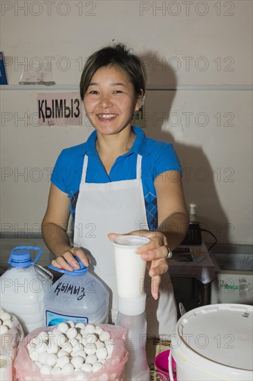 Kazakh woman selling kumis made from mare's milk