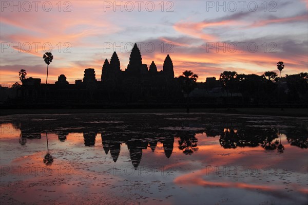 Khmer temple silhouetted at sunrise