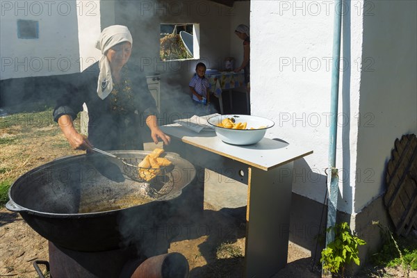 Kazakh woman preparing traditional local tandyr bread