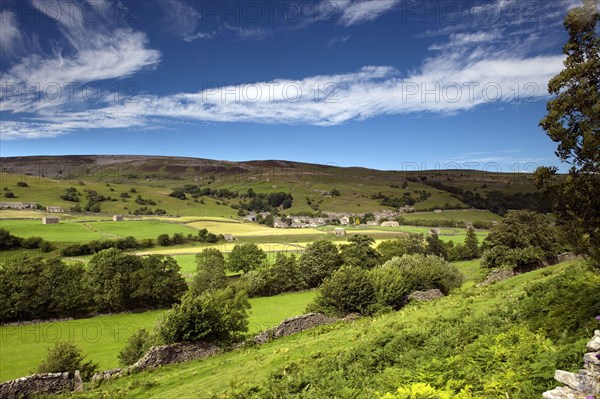 View across River Swale towards village of Gunnerside