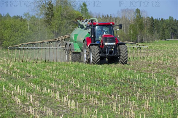 Case 225 Tractor with Samson vacuum slurry tanker and slurry injector injecting slurry into stubble field