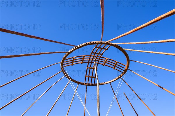 Kazakh men erecting the roof of a yurt