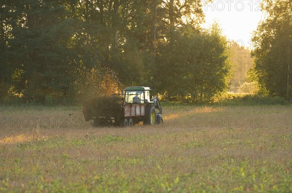 John Deere tractor pulling manure spreader