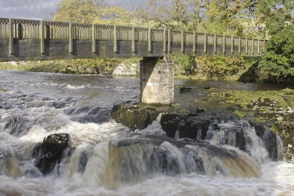 Bridge and cascades over limestone cliffs