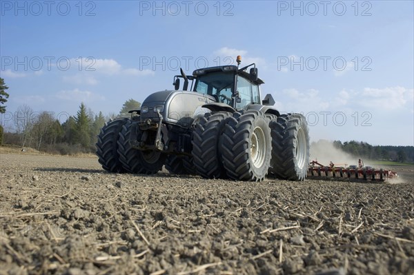 Valtra tractor with Vaderstad NZA-800 and Vaderstad RS-820 harrows and rollers working farmland