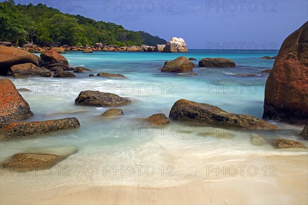 Granite rocks and beach of Anse Lazio in the evening