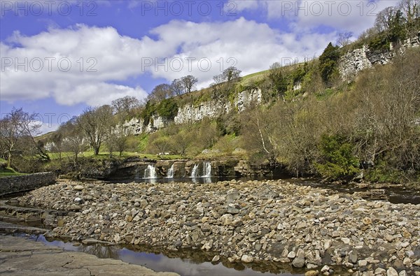 View of a river with waterfalls and limestone cliffs Wainwath Force and Cotterby Scar