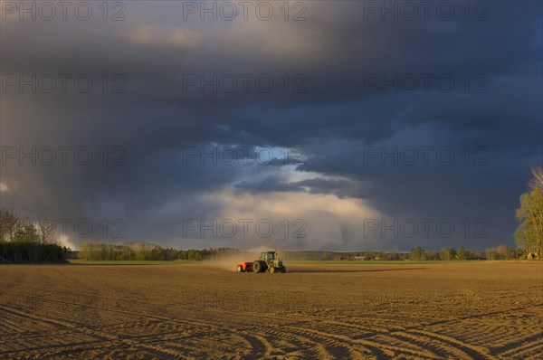 Tractor drilling farmland