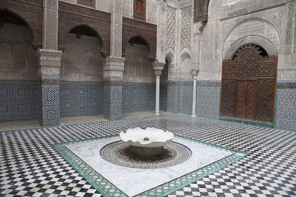 Madrasah courtyard with fountain in city